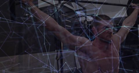 Athletic male doing pull-ups with digital graphic overlay in gym