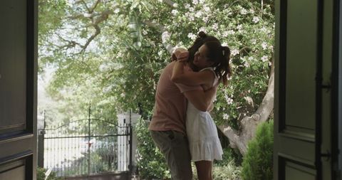 Romantic Embrace at Garden's Entrance with Blooming Flowers