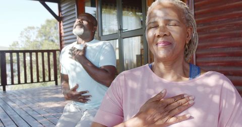 Senior Couple Meditating Peacefully on Sunny Porch