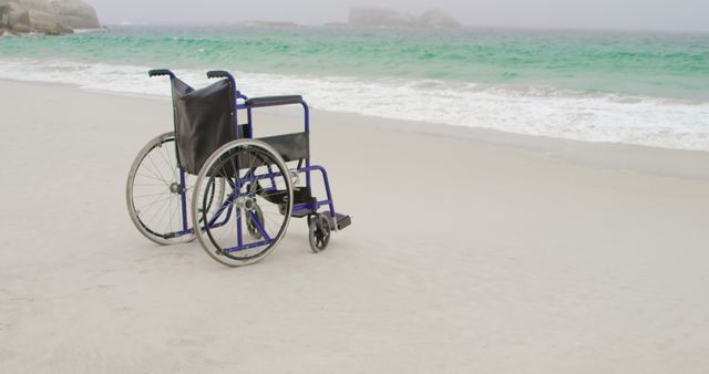 An empty wheelchair sits on a sandy beach facing the sea, suggesting themes of travel, disability, accessibility, and perhaps loneliness or contemplation. Suitable for articles and content related to travel, healthcare, accessible tourism, or emotional reflections on life and freedom.