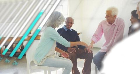 Senior group engaging in friendly discussion during community meeting with teal accent