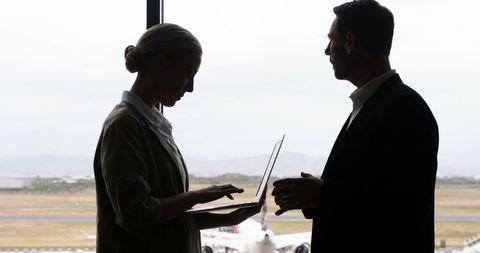 Business professionals collaborating at airport lounge