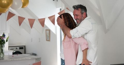 Man surprising partner with special meal in cozy home celebration