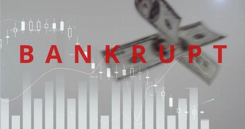 Bold red bankrupt headline over falling financial charts and blurred us dollar notes