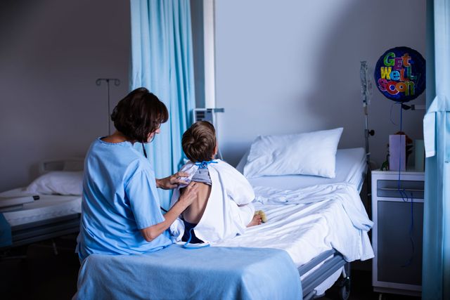 Female doctor using stethoscope to examine patient sitting on hospital bed. Ideal for healthcare, medical services, patient care, and hospital-related content. Useful for illustrating doctor-patient interactions, medical examinations, and healthcare environments.