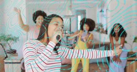 Living room karaoke party woman singing into hairbrush while friends film and dance