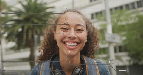 Young woman smiling on urban street wearing headphones and backpack with digital overlay