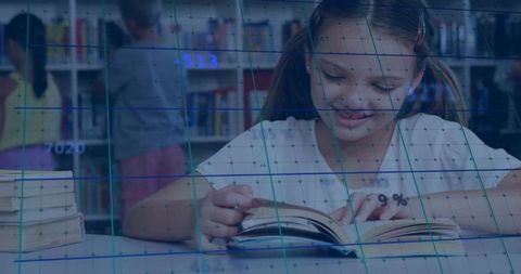 Young girl engaged in reading at school library desk
