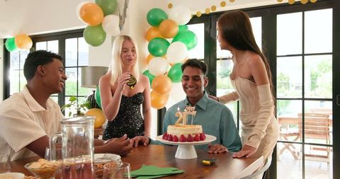 Friends Celebrating Birthday Party with Cake and Balloons