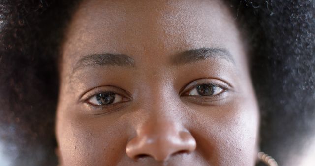 Close-up View of Young Woman with Natural Hair Looking into Camera - Download Free Stock Images Pikwizard.com