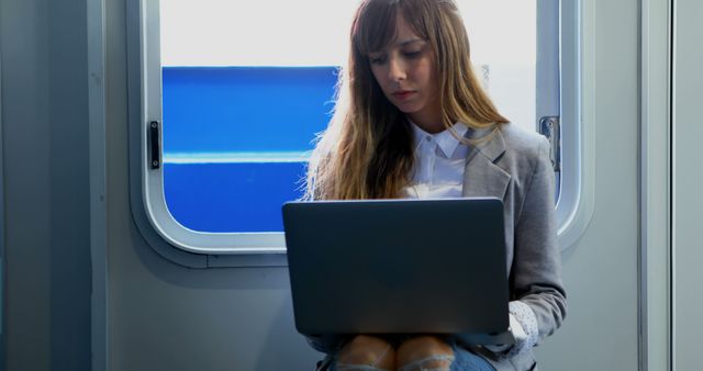 Young Businesswoman Working on Laptop in Train - Download Free Stock Images Pikwizard.com