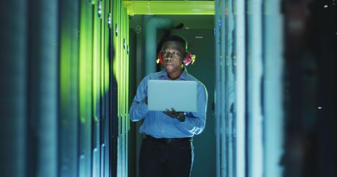 Tech Professional Analyzing Laptop in Secure Server Room - Download Free Stock Images Pikwizard.com