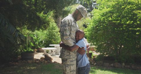 Military Father Embracing Son in Sunny Garden Setting - Download Free Stock Images Pikwizard.com