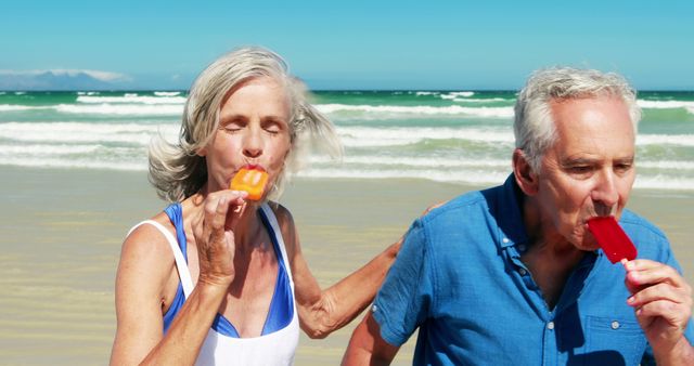 Happy Elderly Couple Enjoying Ice Pops on the Beach - Download Free Stock Images Pikwizard.com