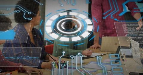 Startup team collaborating around augmented reality interface showing data visualizations
