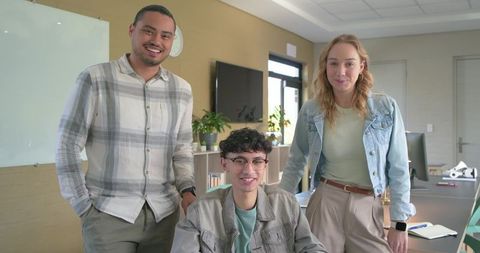 Young diverse team collaborating in bright modern office smiling professionals