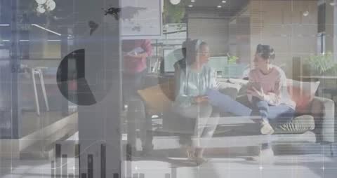 Business Team Collaborates with Graphs in Modern Office