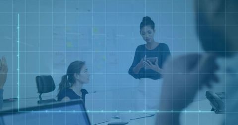 Businesswoman Presenting Data on Tablet during Team Meeting