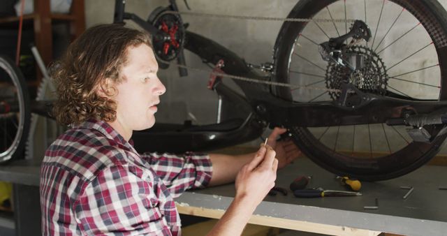 Man Repairing Bike in Workshop with Tools - Download Free Stock Images Pikwizard.com