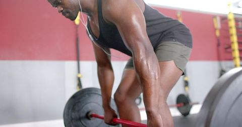Focused African American Man Deadlifting in Gym