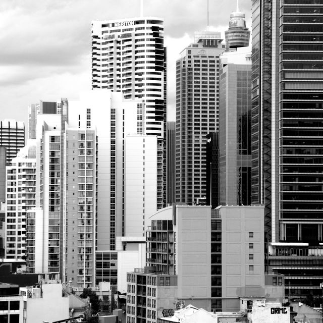 Stunning black and white depiction of modern city buildings creating an urban skyline. This can be used for real estate, architecture presentations, or city planning brochures. Ideal for expressing themes of urban development, modern living, and city life.