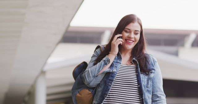 Smiling Woman Talking on Phone While Walking Outdoors - Download Free Stock Images Pikwizard.com