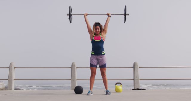 Female Athlete Lifting Barbell During Outdoor Workout by the Sea - Download Free Stock Images Pikwizard.com