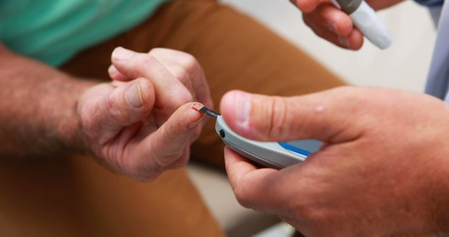 Close-Up of Hands Using Glucometer for Blood Sugar Test - Download Free Stock Images Pikwizard.com