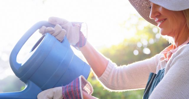 Senior Woman Gardening with Watering Can in Sunlit Garden - Download Free Stock Images Pikwizard.com