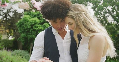 Couple sharing intimate moment by dancing in beautiful outdoor setting emphasizes love and happiness suitable for use in wedding invitations, romance and relationship articles, and event planning promotions. Bright atmosphere conveys joyful feelings perfect for lifestyle and cultural diversity themes.