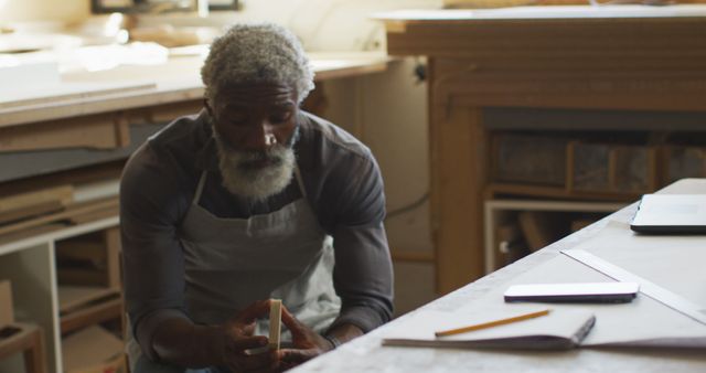 Senior Craftsman Contemplating Wooden Project in Workshop - Download Free Stock Images Pikwizard.com