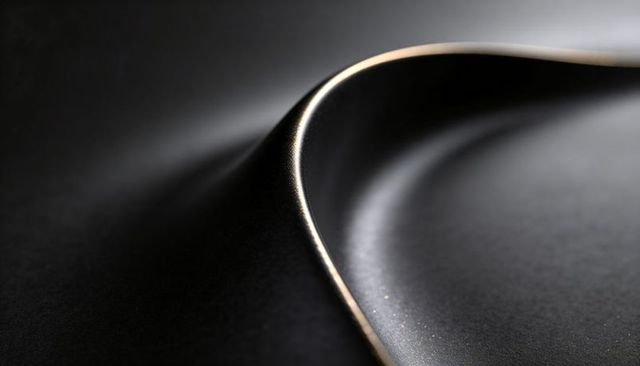 Curved metallic rim creating s-shaped highlight on dark gloss surface minimalist design