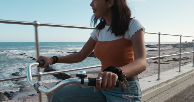 Young Woman Cycling on Seaside Boardwalk - Download Free Stock Images Pikwizard.com