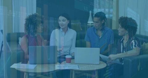 Colleagues Collaborating in Office Lounge with Financial Insights