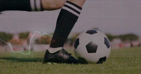 Female Soccer Player Kicking Ball on Grass Field