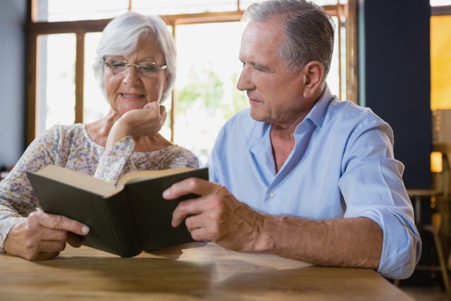 Senior couple reading book - Download Free Stock Photos Pikwizard.com