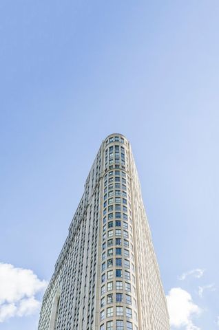 Modern condo skyscraper with clear blue sky background