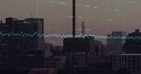 Displaying turquoise data overlay across dusk urban skyline through window mullion and antenna