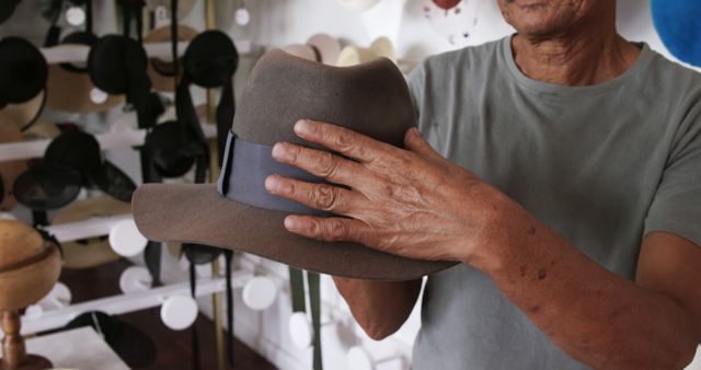 Senior Man Holding Fedora Hat in Hat Shop - Download Free Stock Images Pikwizard.com