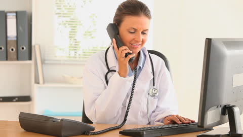 Doctor Multitasking: Taking Phone Call and Typing Reports