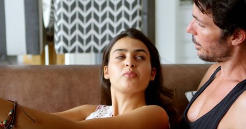 Couple Relaxing at Home Sharing Intimate Moment on Couch