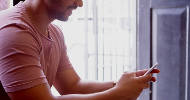 Smiling Man Using Smartphone in Bright Room - Download Free Stock Images Pikwizard.com