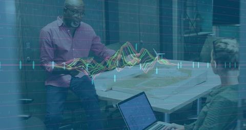 Collaborating architects analyzing blueprints with data overlay for design planning