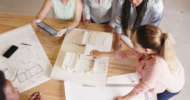 Diverse Group of Female Architects Collaborating on Architectural Project - Download Free Stock Images Pikwizard.com