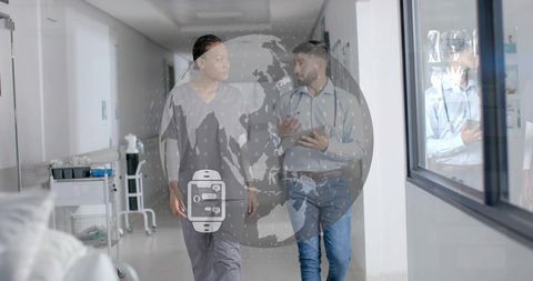 Clinicians walking in hospital corridor discussing telehealth data and wearable monitoring