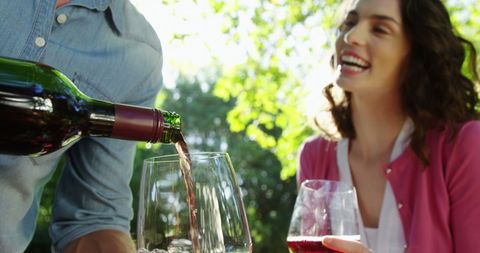 Couple enjoying wine tasting experience outdoors