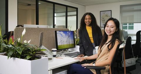 Colleagues collaborating in modern eco-friendly office workspace