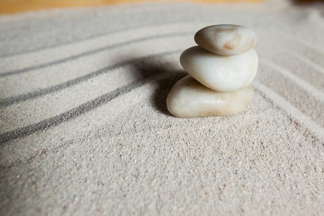 Stack of white pebbles stone on a sand