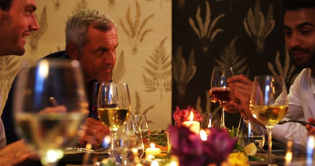 Group of Friends Enjoying Dinner at Restaurant with Wine and Candles - Download Free Stock Images Pikwizard.com