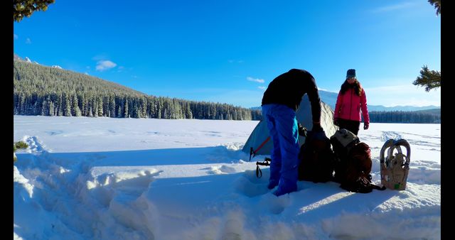 Couple Camping in Snowy Winter Landscape Setting Up Tent - Download Free Stock Images Pikwizard.com